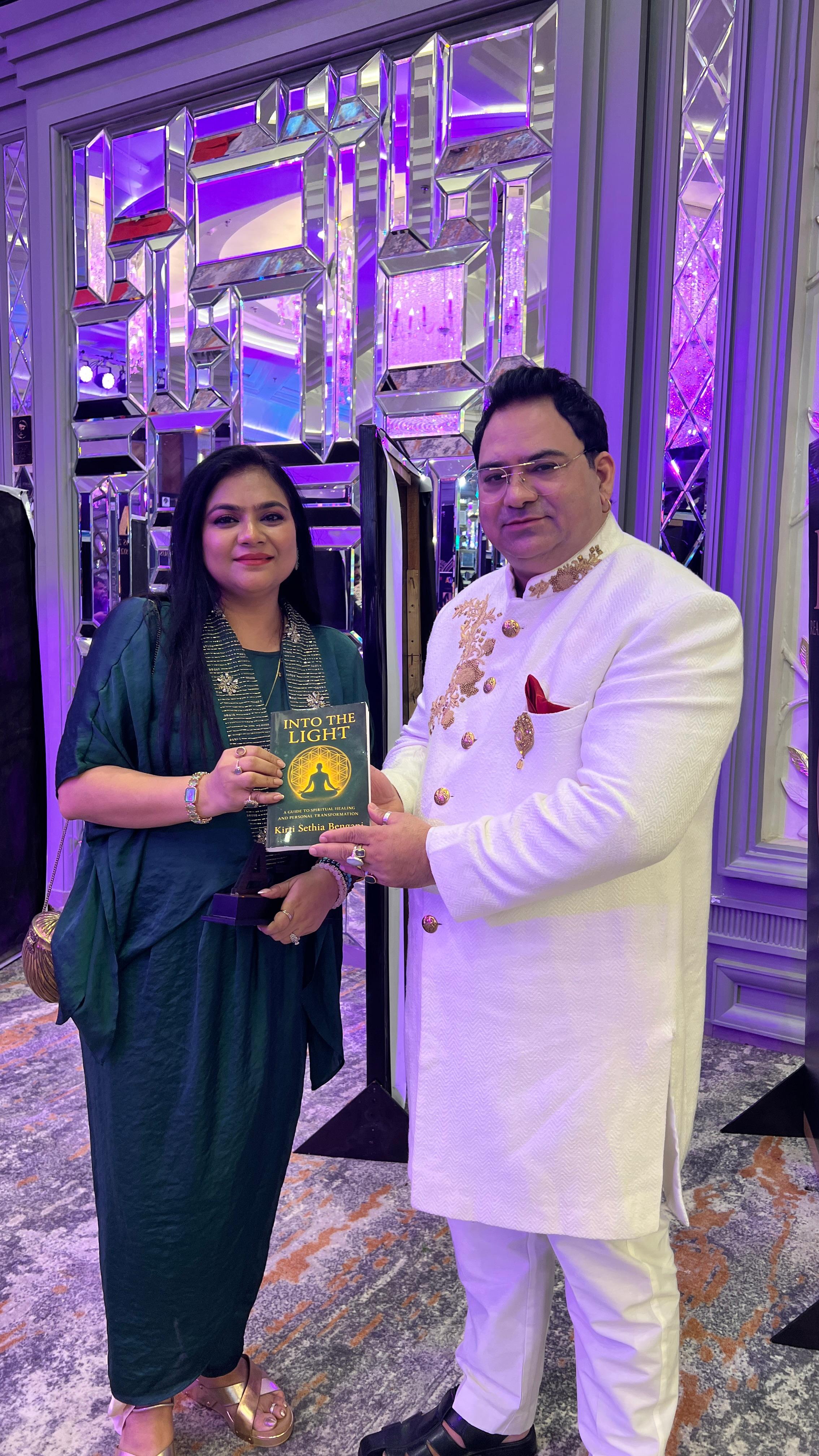 Kirti Sethia Bengani gifting her book to astrologer Sanjiv Thakur